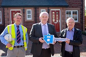 Handing over the key at Brampton Rural Housing Society