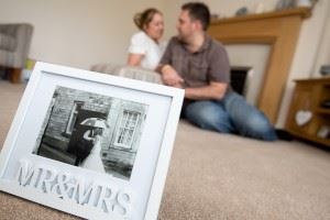 kelly-and-joe-smith-with-wedding-photo-in-lounge