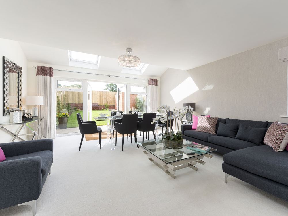 Spacious lounge with French doors leading to a turfed rear garden