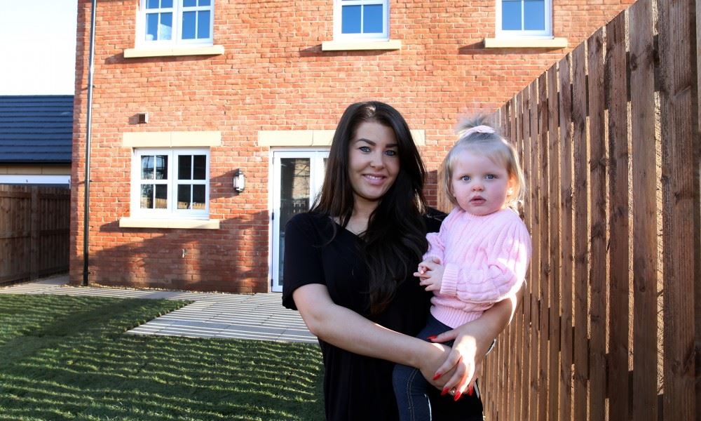 Customer and daughter outside their new build home at St Edmunds Manor