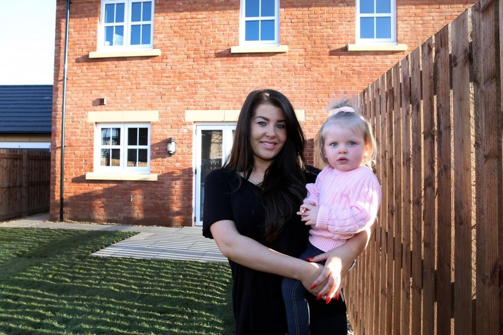 Customer and daughter outside their new build home at St Edmunds Manor