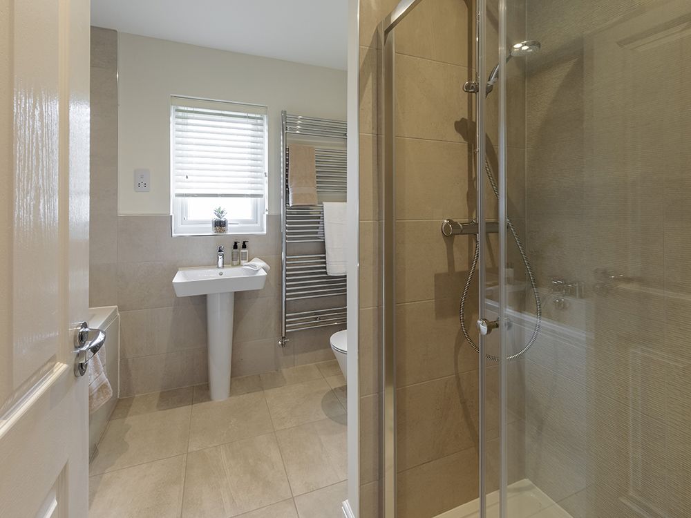 Extensively tiled family bathroom with separate shower and Porcelanosa tiles
