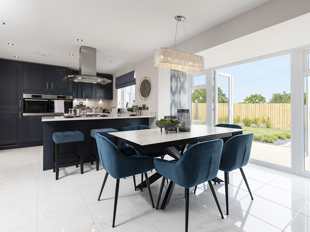 Integrated kitchen/dining/family area with French doors leading to a rear garden