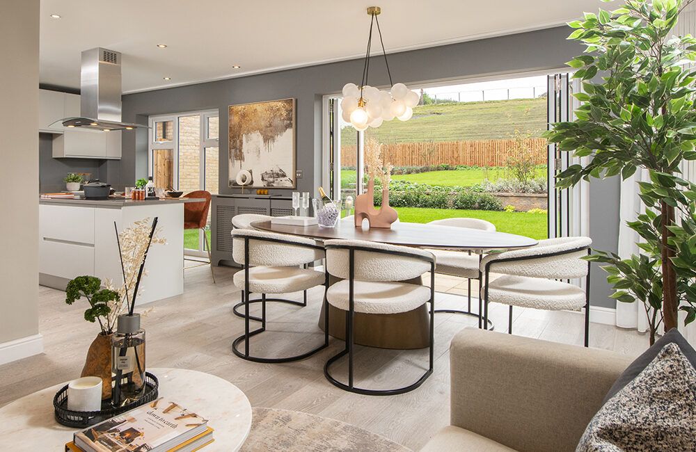 Bi-fold doors opening onto a paved patio and large turfed garden