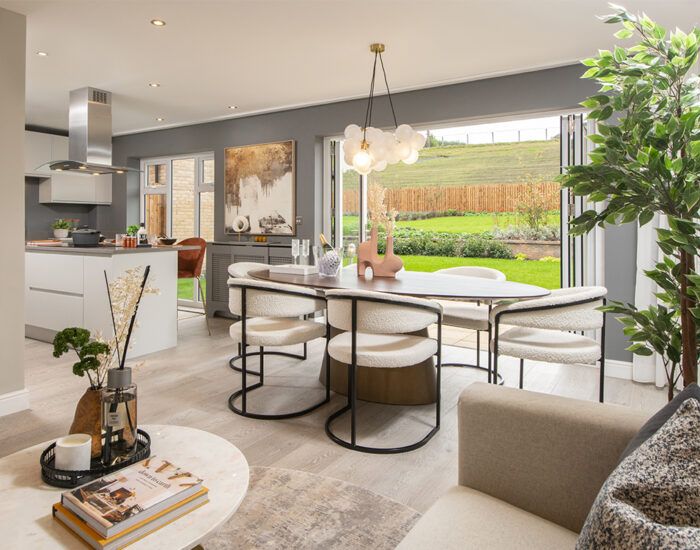 Bi-fold doors opening onto a paved patio and large turfed garden