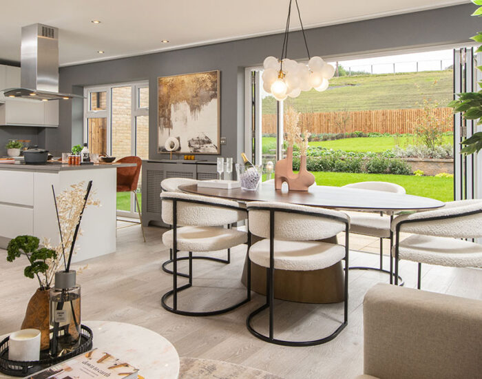 Bi-fold doors opening onto a paved patio and large turfed garden