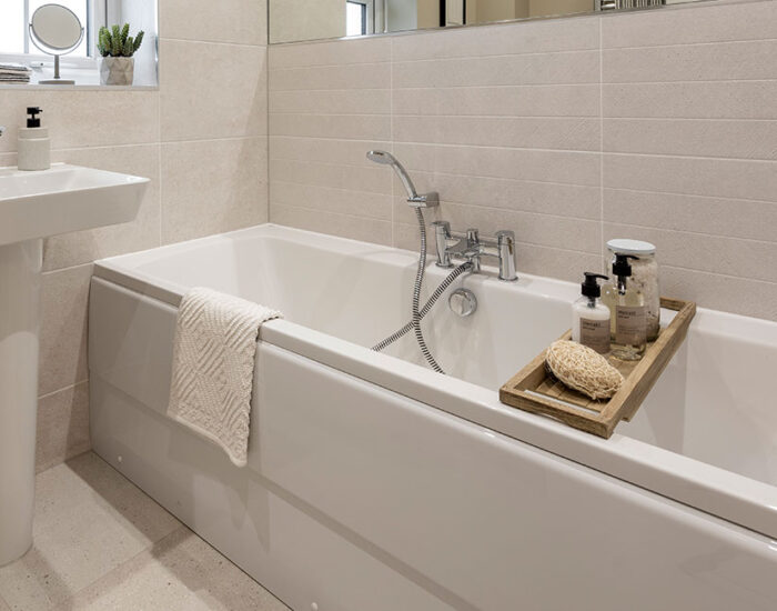 Double ended bath in bathroom and rainfall shower in the en-suite