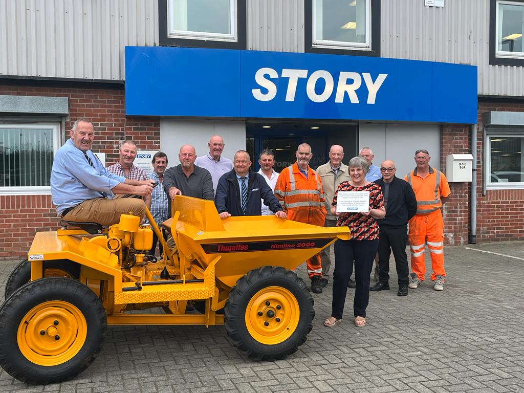 Long service members of staff with an original dumper - the first piece of plant equipment used by Story Construction