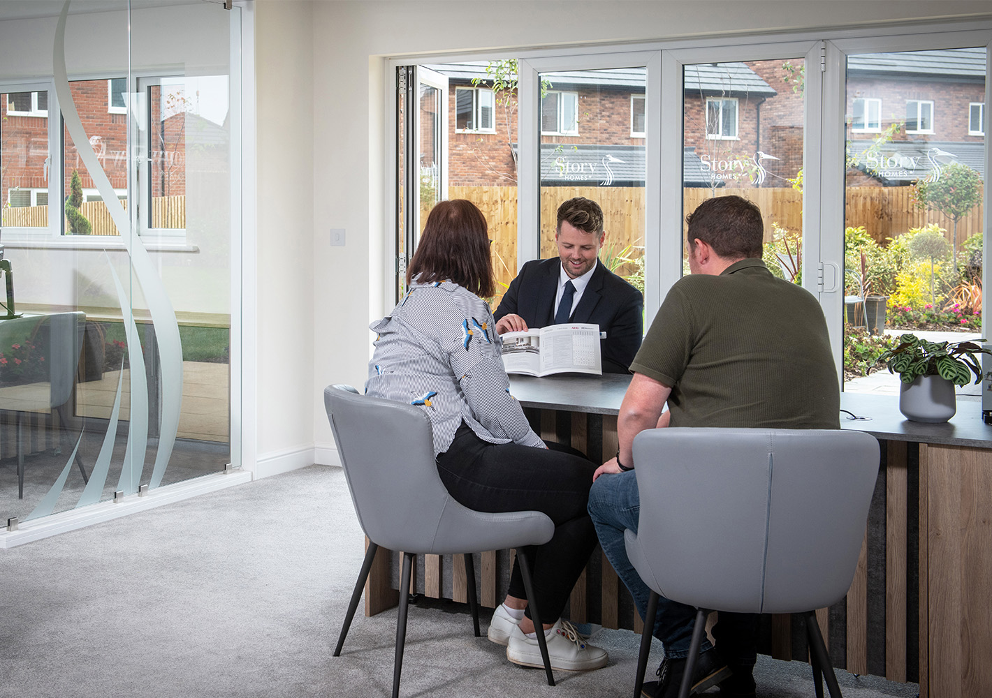 Sales Executive and customers looking at reservation checklist