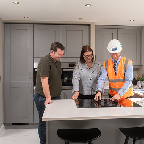 Site Manager showing customers how to operate the induction hob in their new Story home