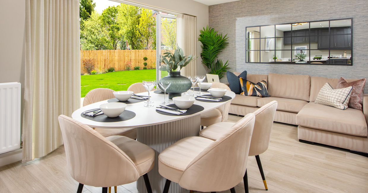 Bi-fold doors opening onto a paved patio and large turfed garden