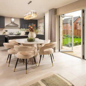 A view of a kitchen and dining area from a Sanderson show home at Ashwood Grange, by Story Homes.