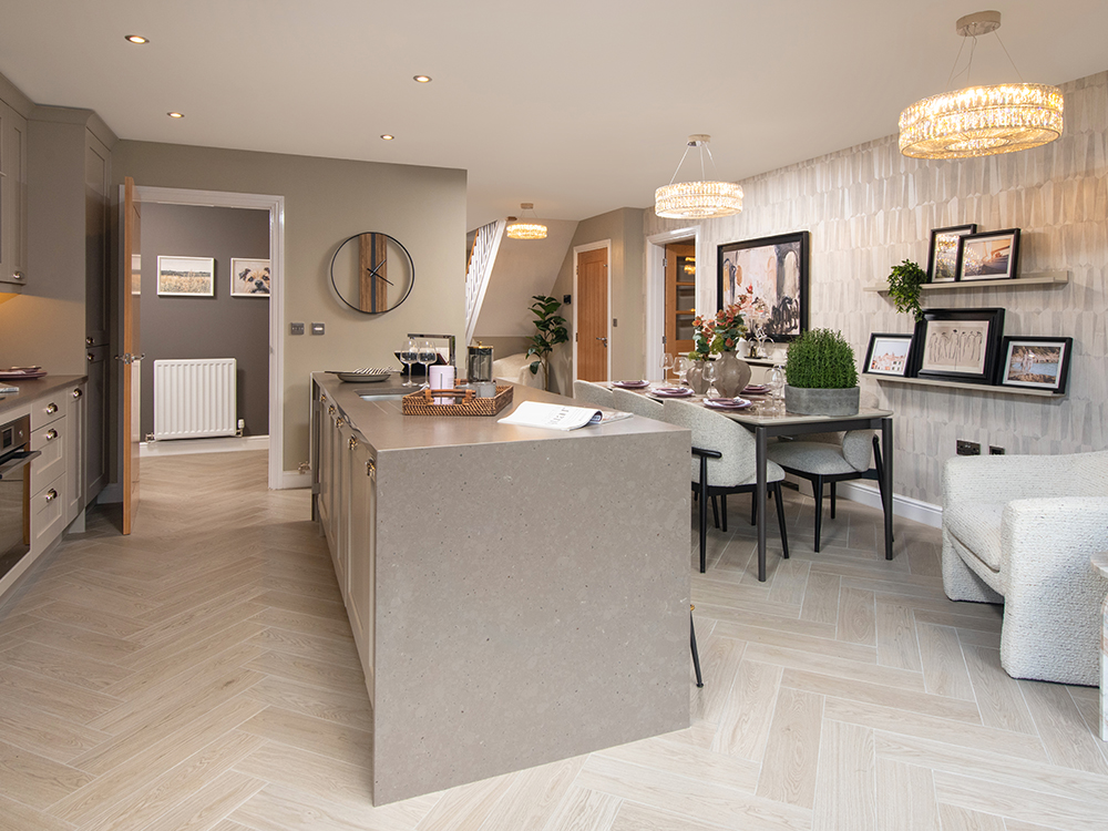 A view of a kitchen and dining area from a Milford show home at Ashwood Grange, by Story Homes.