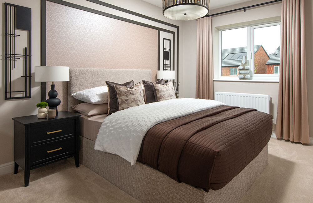 A view of the bedroom and a double bed in a Sanderson show home at Stonebrook Meadows at Story Homes.
