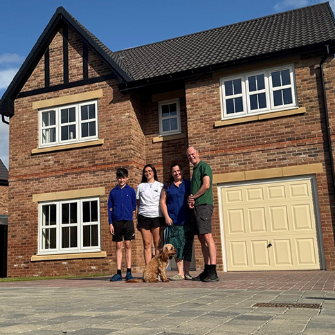 Lisa, Jonathan and family outside their new Hewson home at Heritage Fields