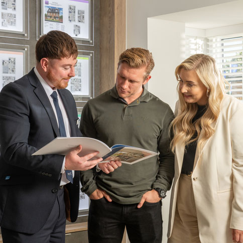 Customers and Sales Executive Looking at Brochure