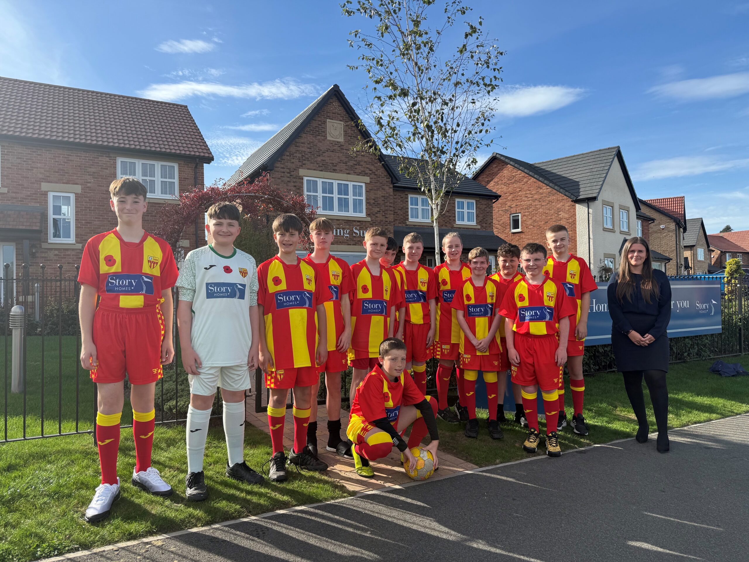 Longhoughton Rangers U13 football team outside of Riverbrook Gardens show homes in Alnwick