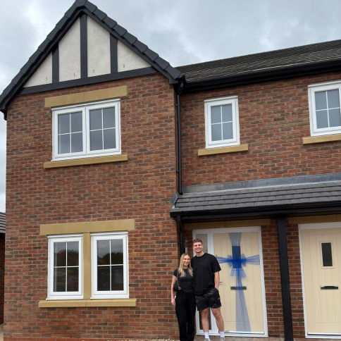 Adam and Alex outside of their new Spencer home at Elmbrook Park.