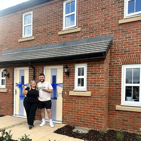 Elle and Adam outside their Harper at Hawksley Rise