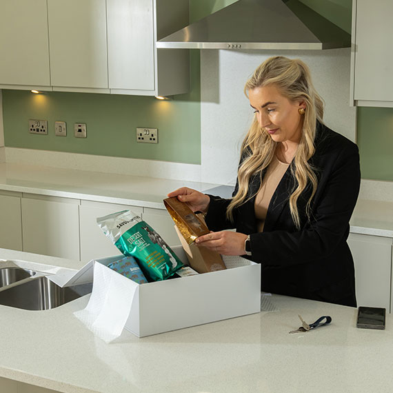 Customer moving into house looking at welcome hamper