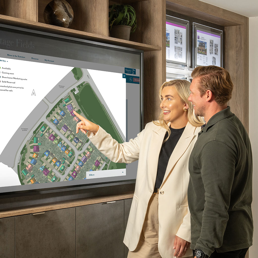 A happy customer picking a plot in the marketing suite