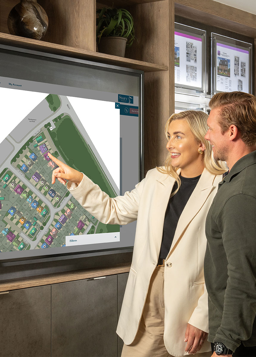 A happy customer picking a plot in the marketing suite