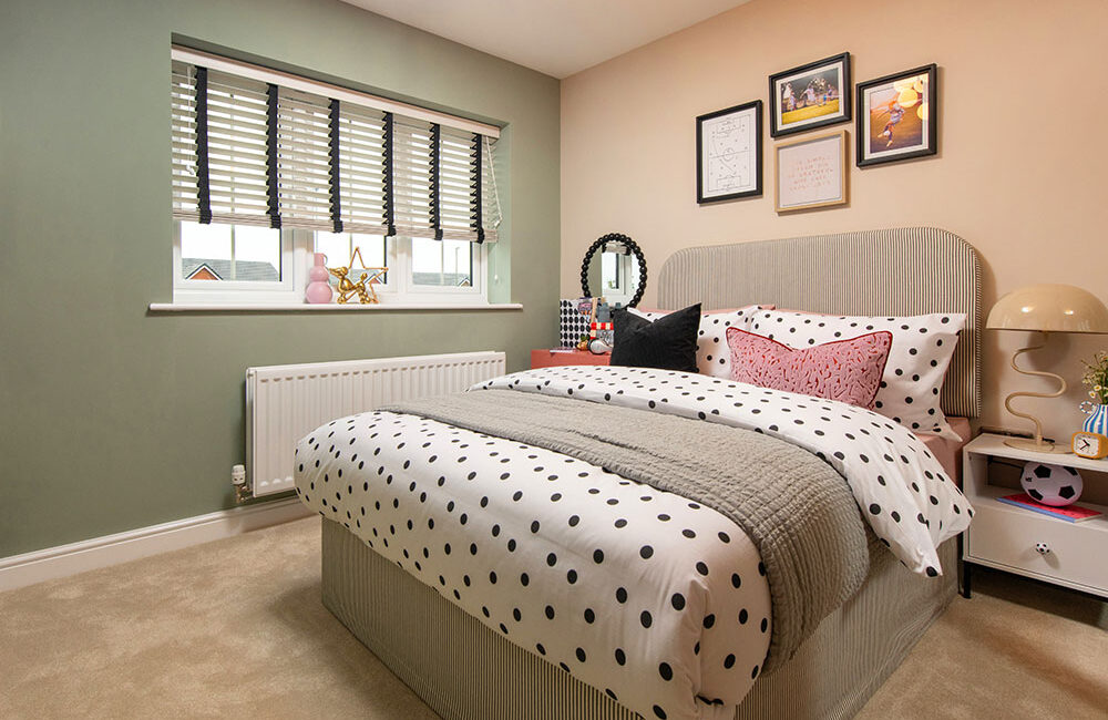 A view of bedroom 3 , including a double bed, in a Lawson show home at Stonebrook Meadows, by Story homes