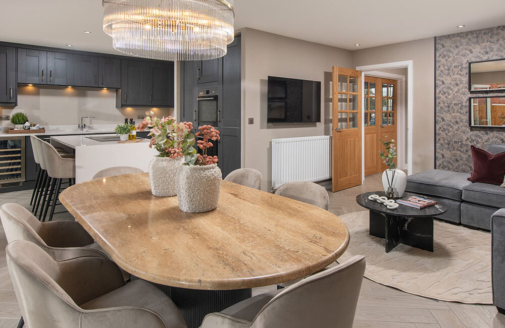 A view of the kitchen, dining and family area in a Lawson show home at Stonebrook Meadows, by Story Homes.