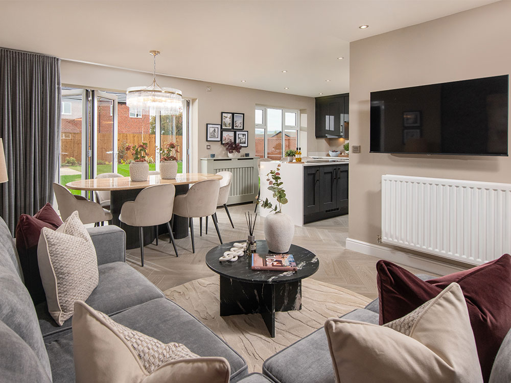 A view of the Kitchen, dining and family area, in a Lawson show home at Stonebrook Meadows by Story Homes.