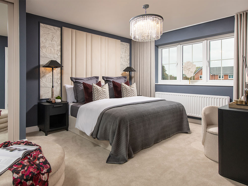 A view of the main bedroom, including a double bed, in a Lawson show home at Stonebrook Meadows by Story Homes.