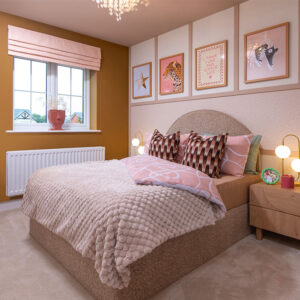 A view of bedroom 3, including a double bed, in a Sanderson shows home at Stonebrook Meadows, by Story Homes.