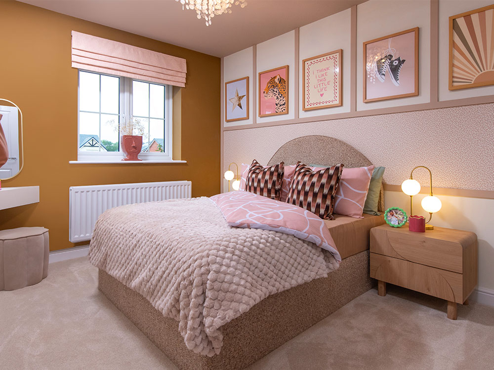 A view of bedroom 3, including a double bed, in a Sanderson shows home at Stonebrook Meadows, by Story Homes.