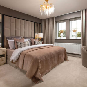 A view of the main bedroom, including a double bed, in a Sanderson show home in Stonebrook Meadows, by Story Homes.
