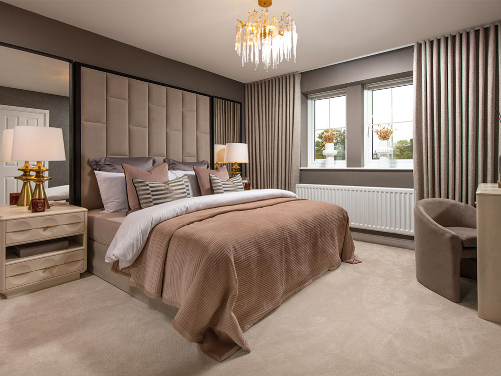 A view of the main bedroom, including a double bed, in a Sanderson show home in Stonebrook Meadows, by Story Homes.