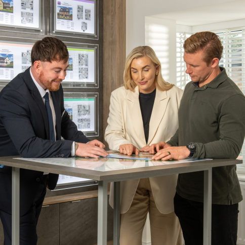 Sales Executive showing customers a Story Homes site map