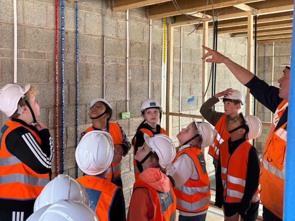 School children being shown inside a house at 'first fix'
