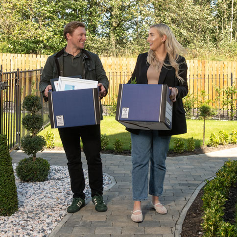 Couple moving home with moving boxes